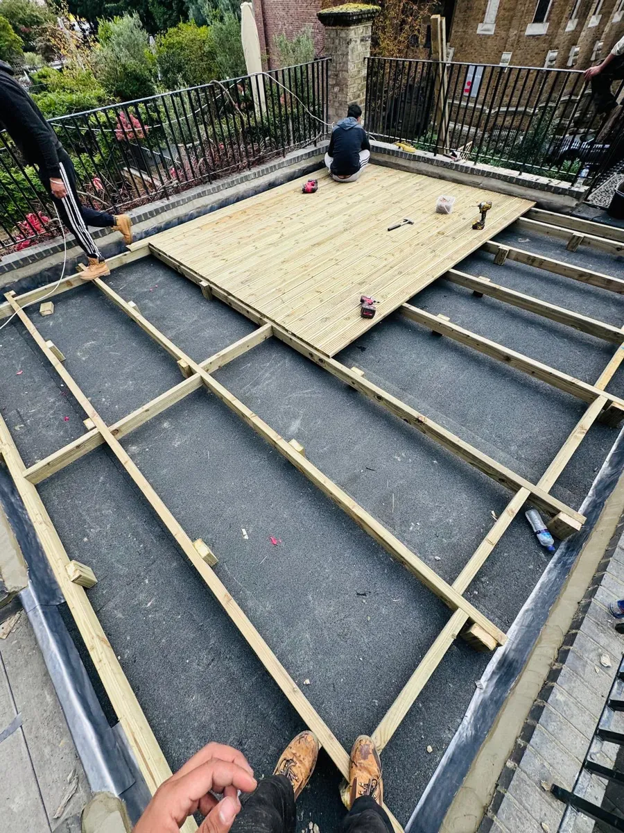 New timber decking going down over a stripped flat roof, Imperial Roofcraft roofing job in London