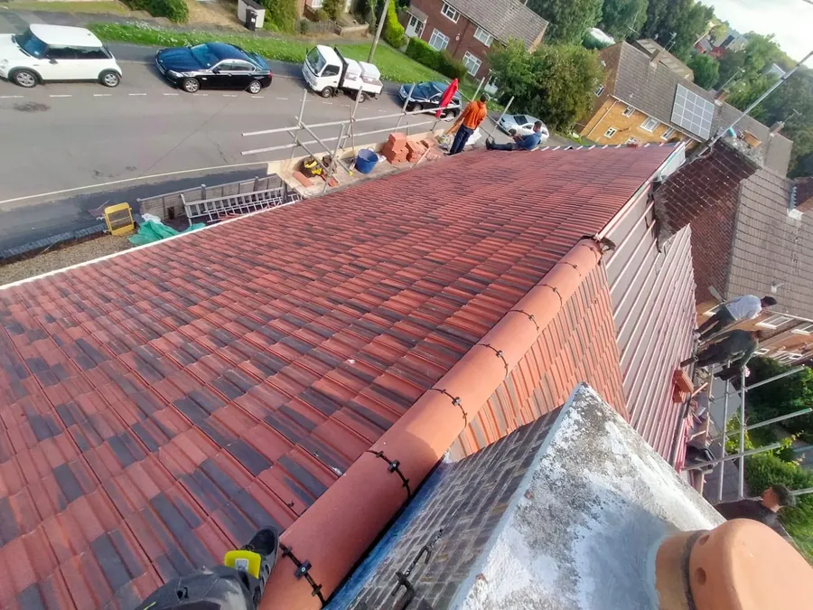 Red and brown tiles going on during a full re-roof, Imperial Roofcraft roofing job in London